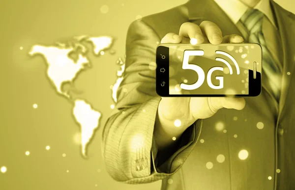 Businessman holding phone with 5G