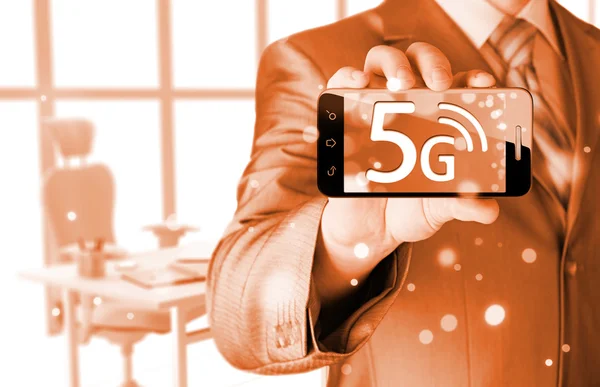 Businessman holding phone with 5G