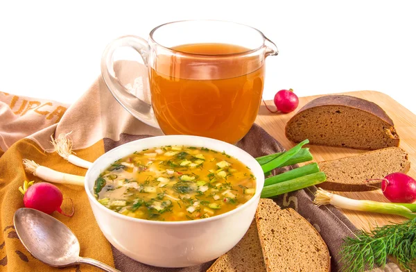 Traditional russian cold soup okroshka, jug with kvass and bread.