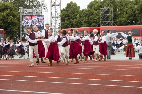 Dancers in traditional costumes perform at the Grand Folk dance concert of Latvian Youth Song and Dance Festival