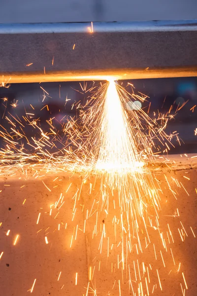 Worker cutting steel pipe using metal torch and install roadside