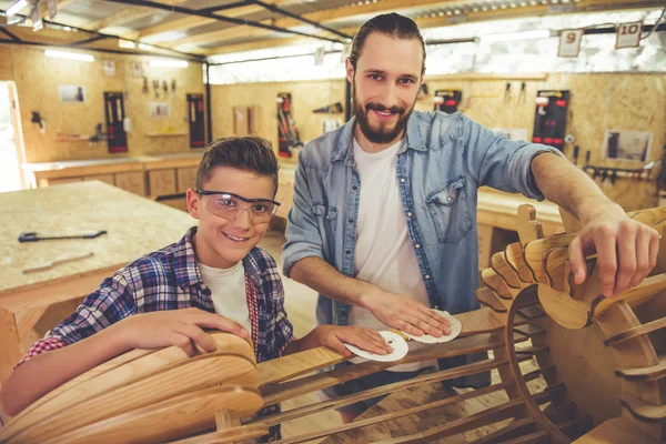 Father and son working with wood