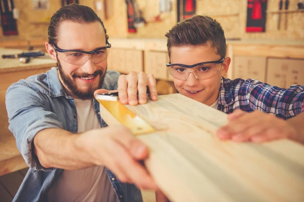 Father and son working with wood