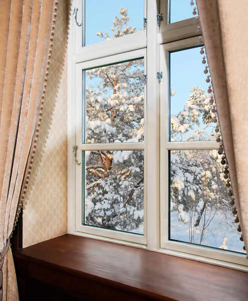 Window with curtains in winter