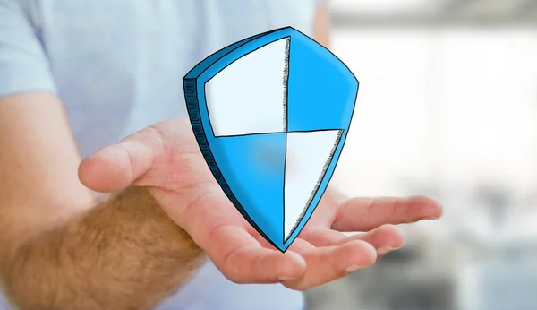 Man holding hand drawn shield safe protection icon