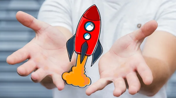 Businessman holding red hand drawn rocket in his hand