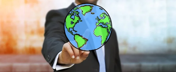 Businessman touching hand drawn planet earth