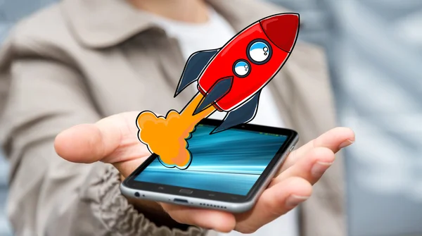 Businessman holding red hand drawn rocket over his mobile phone