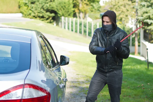 Thief stealing a car
