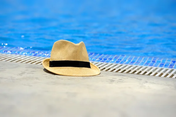 Sun hat on the edge of the pool