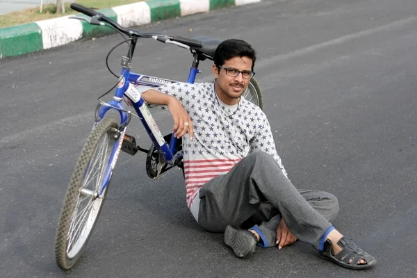Indian young man member Hyderabad Bicycling Club rest on raahgiri day