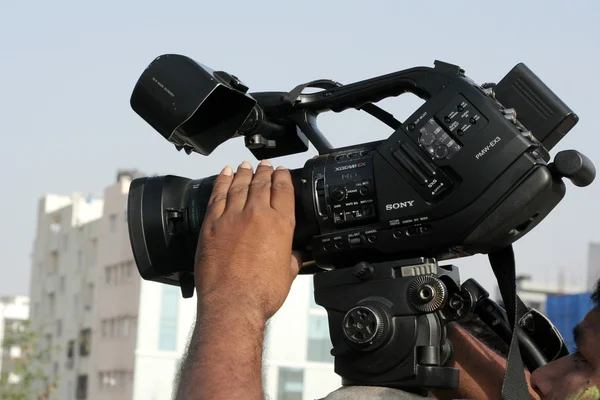 Indian videographer use Video camera to shoot an event