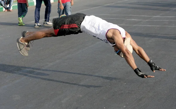 Indian man do push ups and jump up from the floor