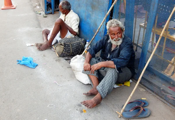 Senior homeless poor Indian men seeking help or alms