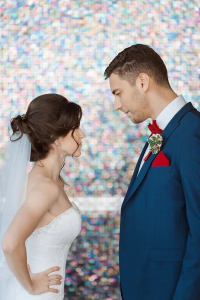 Bride and groom in very bright colored room