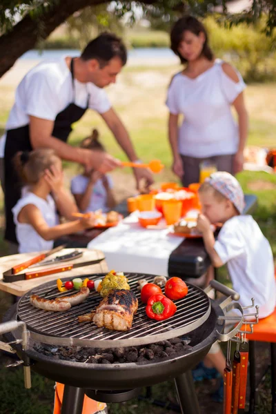 Family on vacation having barbecue