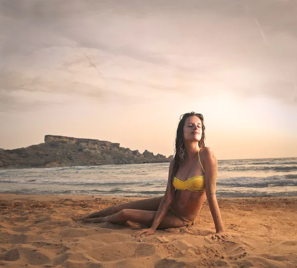 Young girl feeling herself at ease at the beach