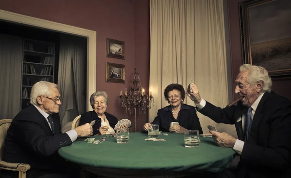 Group of elderly people playing cards