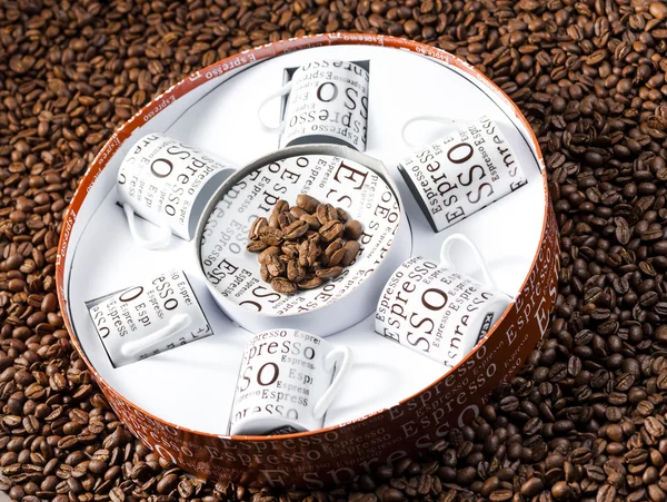 Coffee cups stored in a box on coffee beans