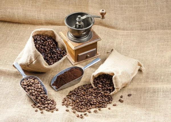 Coffee beans in jute bags with coffee grinder