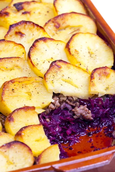 Potatoes baked with pork minced meat and red cabbage
