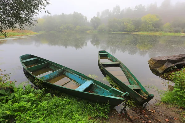 Flooded wooden boats on river