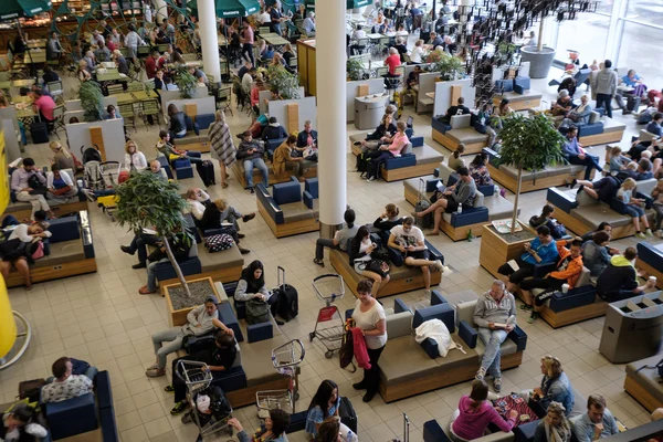 People visit departure hall in international Schiphol airport