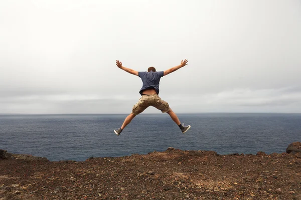 Freedom or adventure concept - jump of young man