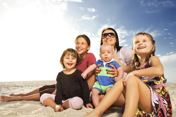 Beautiful family enjoying sunny day at the beach.