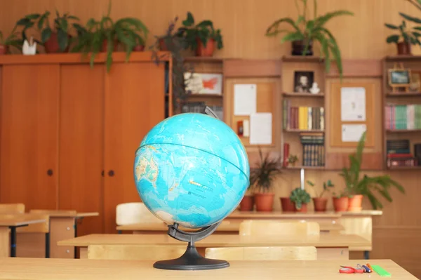 Globe on table in classroom