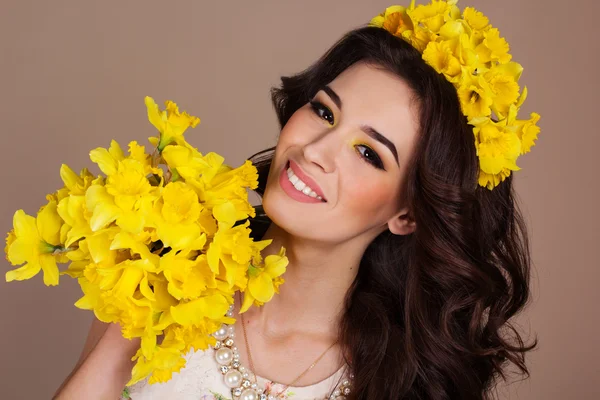 Smiling woman with bouquet of yellow flowers