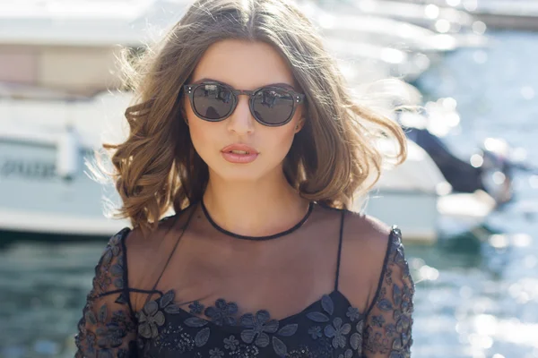Luxury woman is wearing black sunglasses