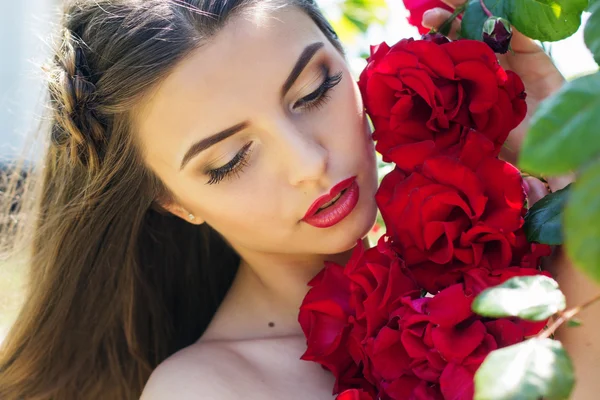 Portrait of girl near red roses
