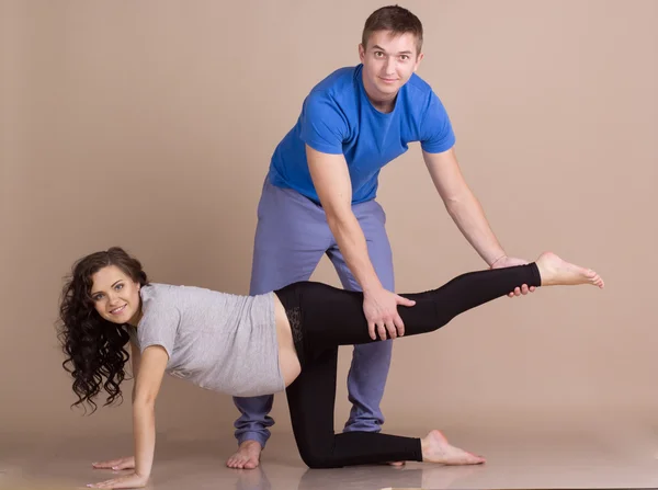 Pregnant girl and man doing sports together