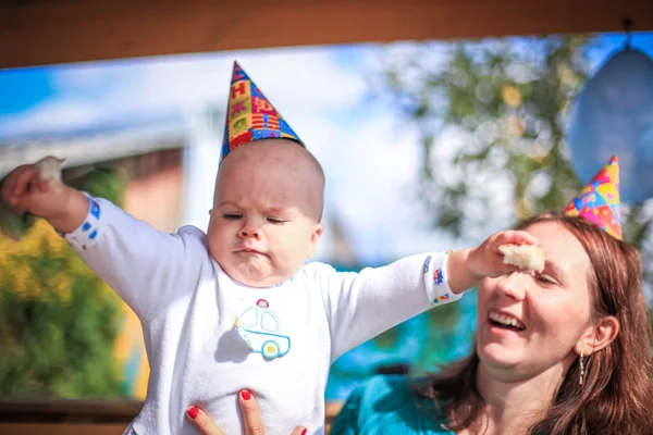 Mom and baby celebrate birthday in sunny day at outdoor