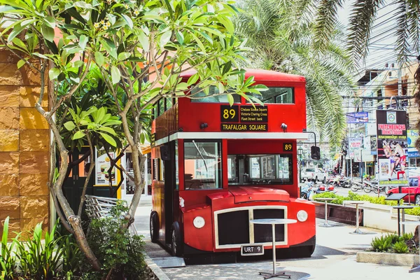 Red bus in Koh Samui at stopping place.
