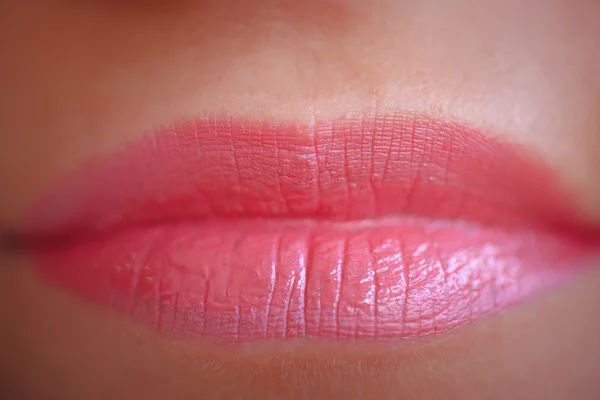 Close-up of womans lips.  Horizontal macro sexy pale lipgloss make Up