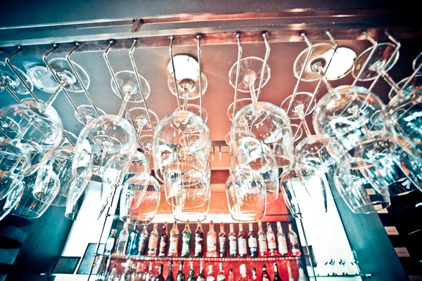 Empty glasses hanging at the bar and Bar with bottles Blurred Background