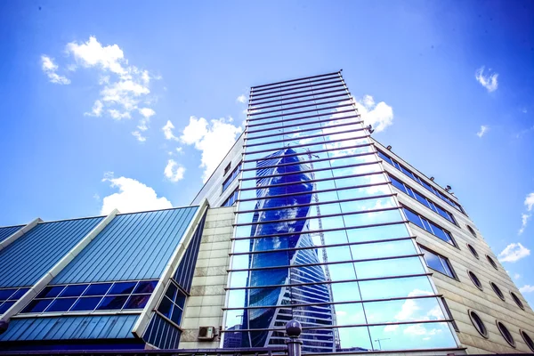 Panoramic and perspective wide angle view to steel blue background of glass high rise building skyscrapers