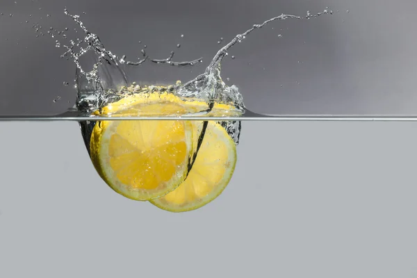 Lime and lemon splash in water
