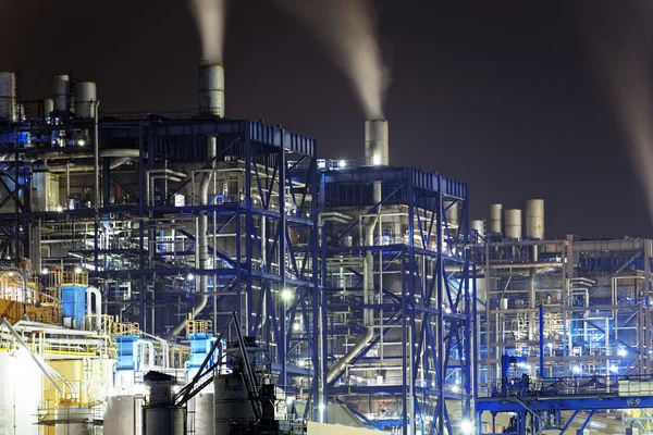 Power station at night with smoke