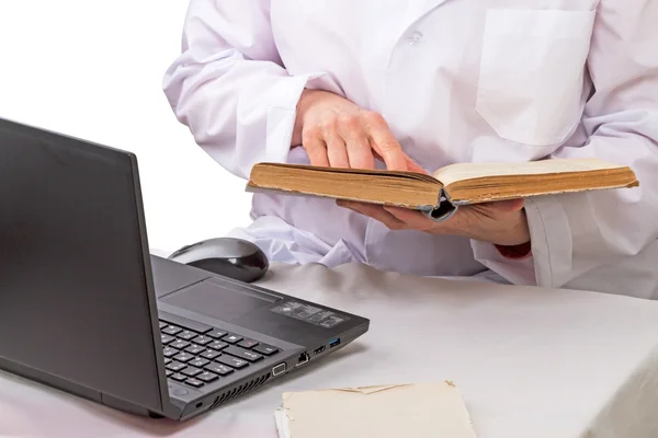 Doctor with book and laptop
