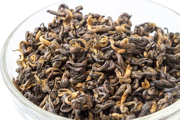 Dry black tea in a glass bowl