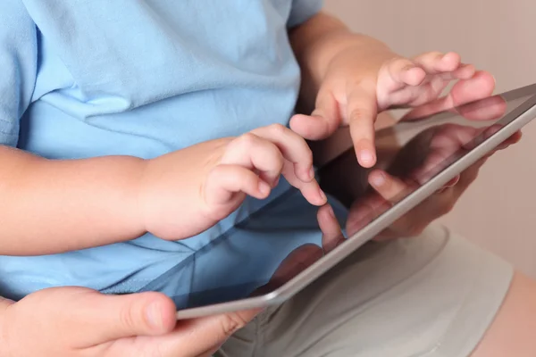 Child and mother using a digital tablet