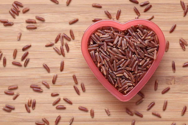 Red rice in a heart shape bowl
