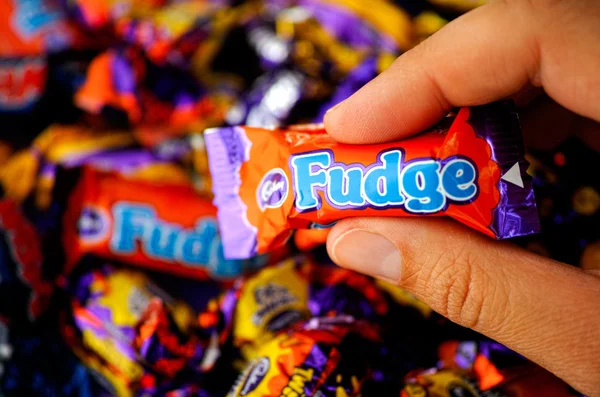 Cadbury Fudge candy in womans hand