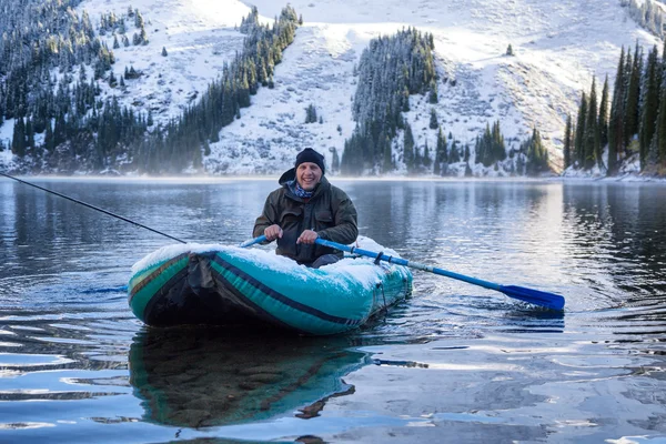 Autumn fishing under snowfall