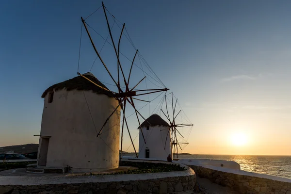 Sunset of White windmills and Aegean sea on the island of Mykonos, Cyclades