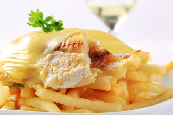Cheese topped fish fillets with French fries