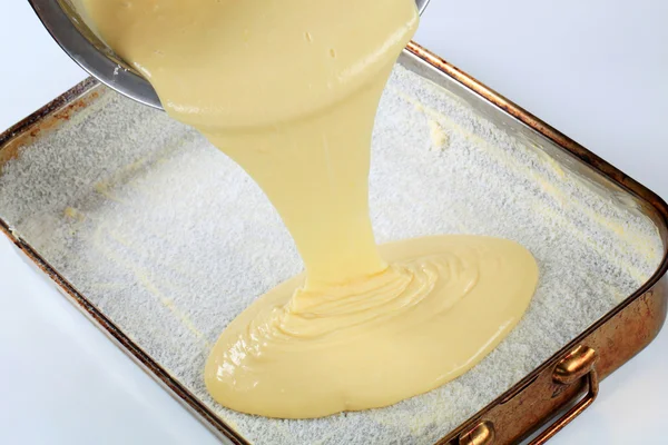 Pouring batter into baking pan